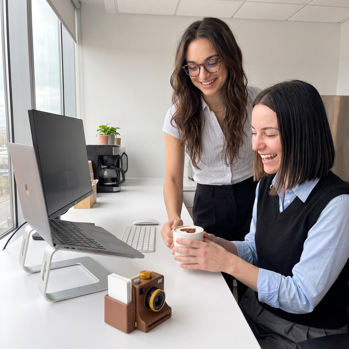Coworkers laughing at a heart latte